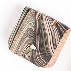 Load image into Gallery viewer, Marbled veg-tanned leather cable tidy, abstract monochrome pattern with silver button closure