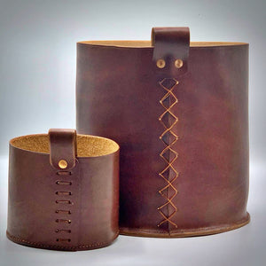 Load image into Gallery viewer, Leather storage bin sized medium and small.  Medium, a commission piece with loop attached with cross stitch and copper rivets.  Small pot also has a hand-stitched base and loop is attached with ladder stitch and copper rivets.  Oak bark veg-tanned leather in Dark London Oak.