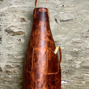 Load image into Gallery viewer, Commissioned veg-tanned leather apron, showing two hand-stitched pockets, personalised riveted label and hand-stitched abstract marbling pattern leather lined ties