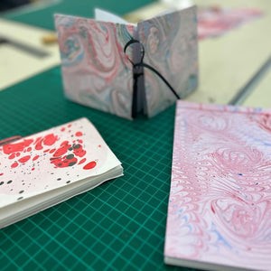 Load image into Gallery viewer, ROCWORX Workshop Attendees books made using marbled papers 
