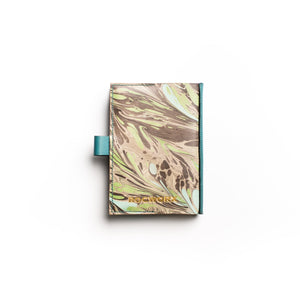 Load image into Gallery viewer, A6 veg-tanned marbled leather journal in Abstract Feathers pattern in Monochrome, Teal and Green. Hand-stitched in teal linen thread in traditional saddle stitch on Dark Teal veg-tanned leather.  Pen holder. Branded for authentic British craftsmanship
