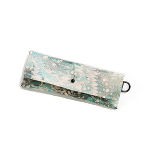 Load image into Gallery viewer, ROCWORX Marbled veg-tanned minimal leather case, with button closure and d-ring. Nonpareil marbling pattern, in Dark Teal, Green and Black with hints of Gold
