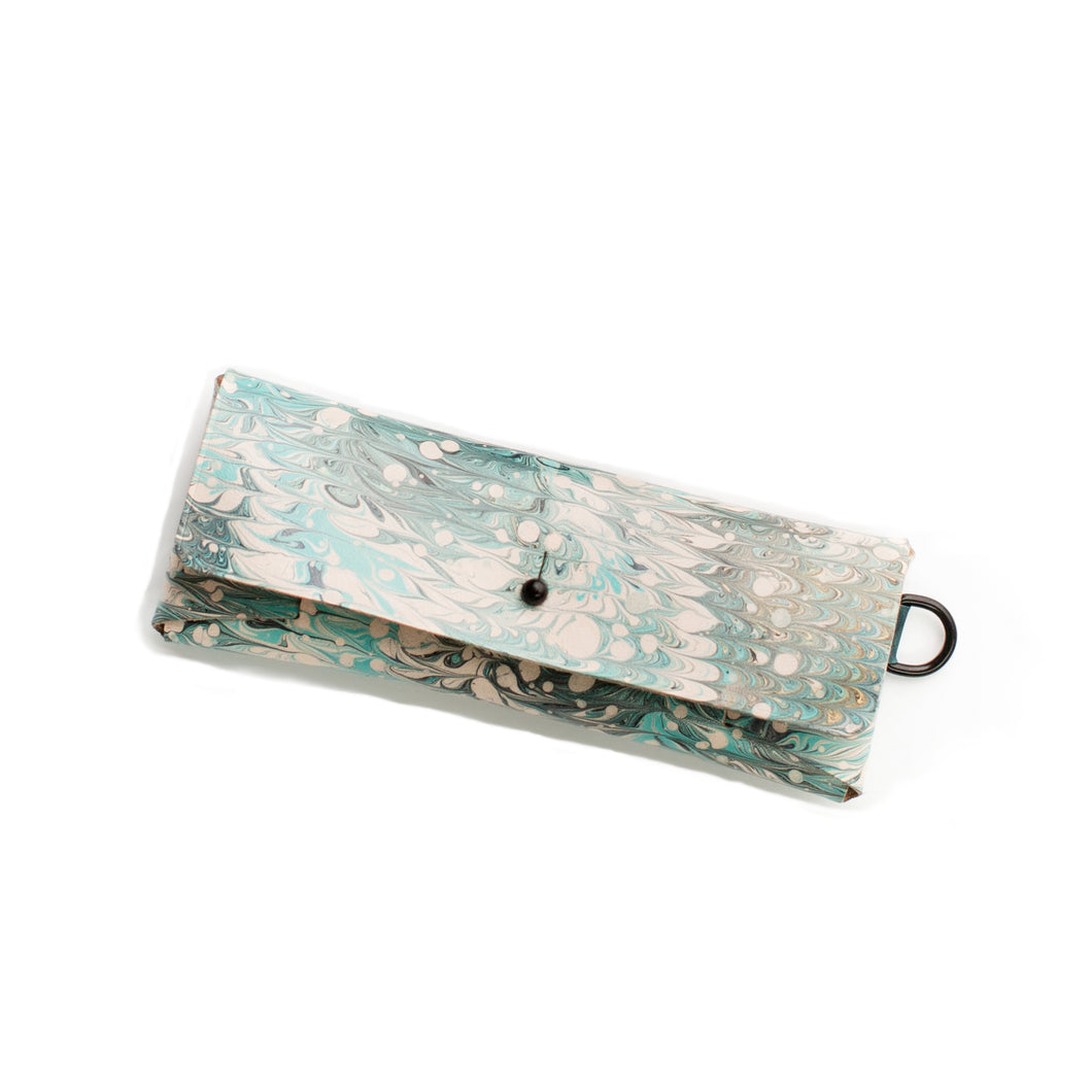 ROCWORX Marbled veg-tanned minimal leather case, with button closure and d-ring. Nonpareil marbling pattern, in Dark Teal, Green and Black with hints of Gold