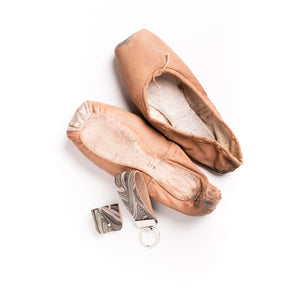 Load image into Gallery viewer, Sustainable textiles project, deconstructing leather from Royal Opera House ballet slippers to create marbled leather key fob, on a silver key ring and a cable tidy with a silver button closure
