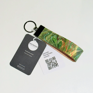 Load image into Gallery viewer, Marbled leather from repurposed ballet slippers donated by The Royal Ballet and Opera, with proceeds of sales going to the food bank charity.  Leather is marbled in green, teal and orange, set on a silver key ring.
