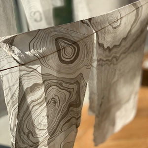 Load image into Gallery viewer, Student ink marbled silk scarves hanging to dry
