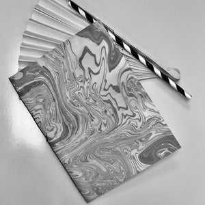 Load image into Gallery viewer, Suminagasho paper stitched book with fan and straw
