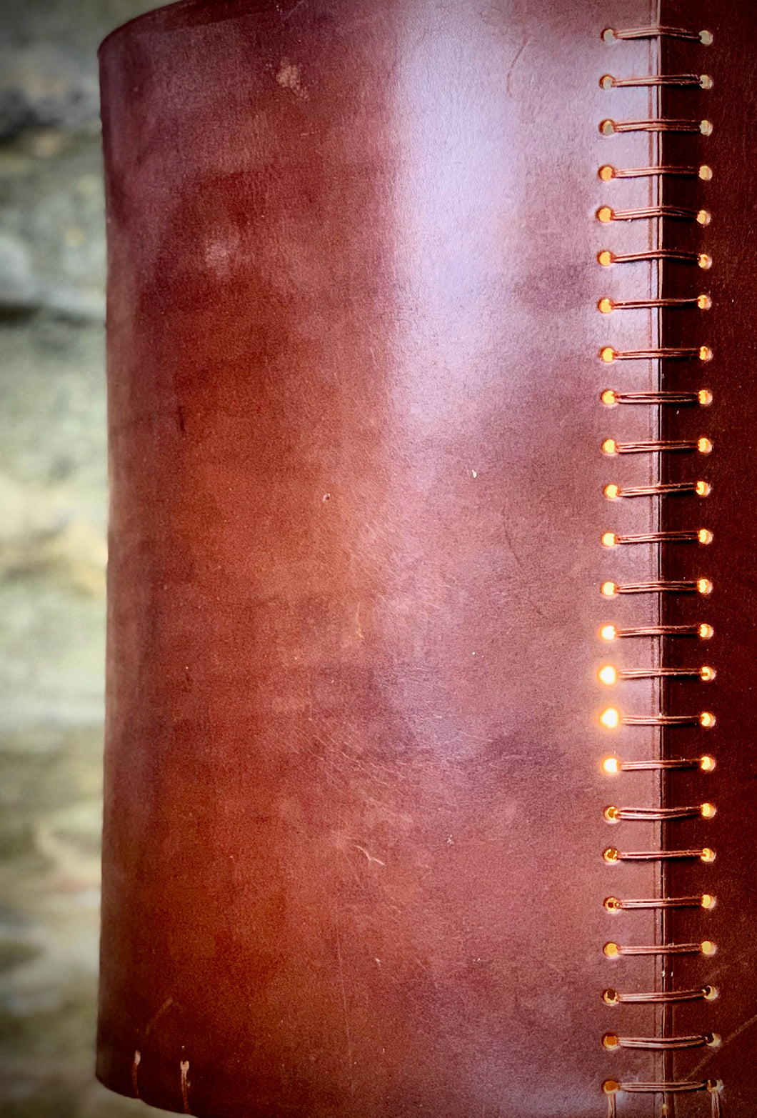 ROCWORX.  Detail of the RUGGLESTONE Leather Lampshade in Dark London Tan.  Ladder stitched in waxed linen thread and repurposed electrical copper wire.