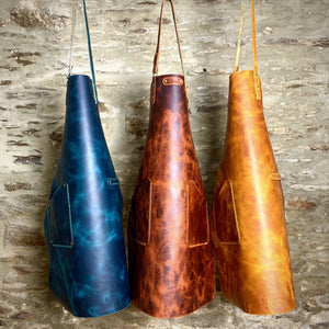 Load image into Gallery viewer, Italian veg-tanned colour waxed leather apron, with marbled ties, adjustable neck tie and choice of plain leather pocket, marbled leather pocket or chef&#39;s towel slot.  Branded for authentic British craftsmanship
