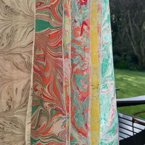 Load and play video in Gallery viewer, Marbled silk scarves hanging to dry in the garden.
